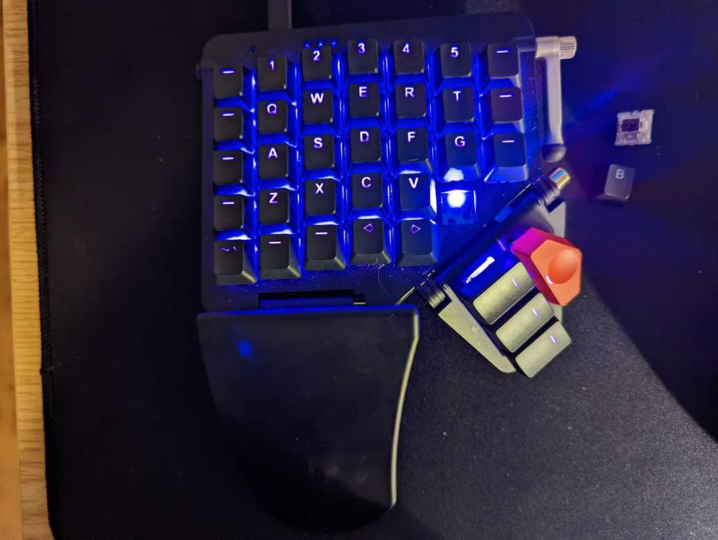 My current keyboard with a switch removed, showing the LED glowing on the PCB underneath